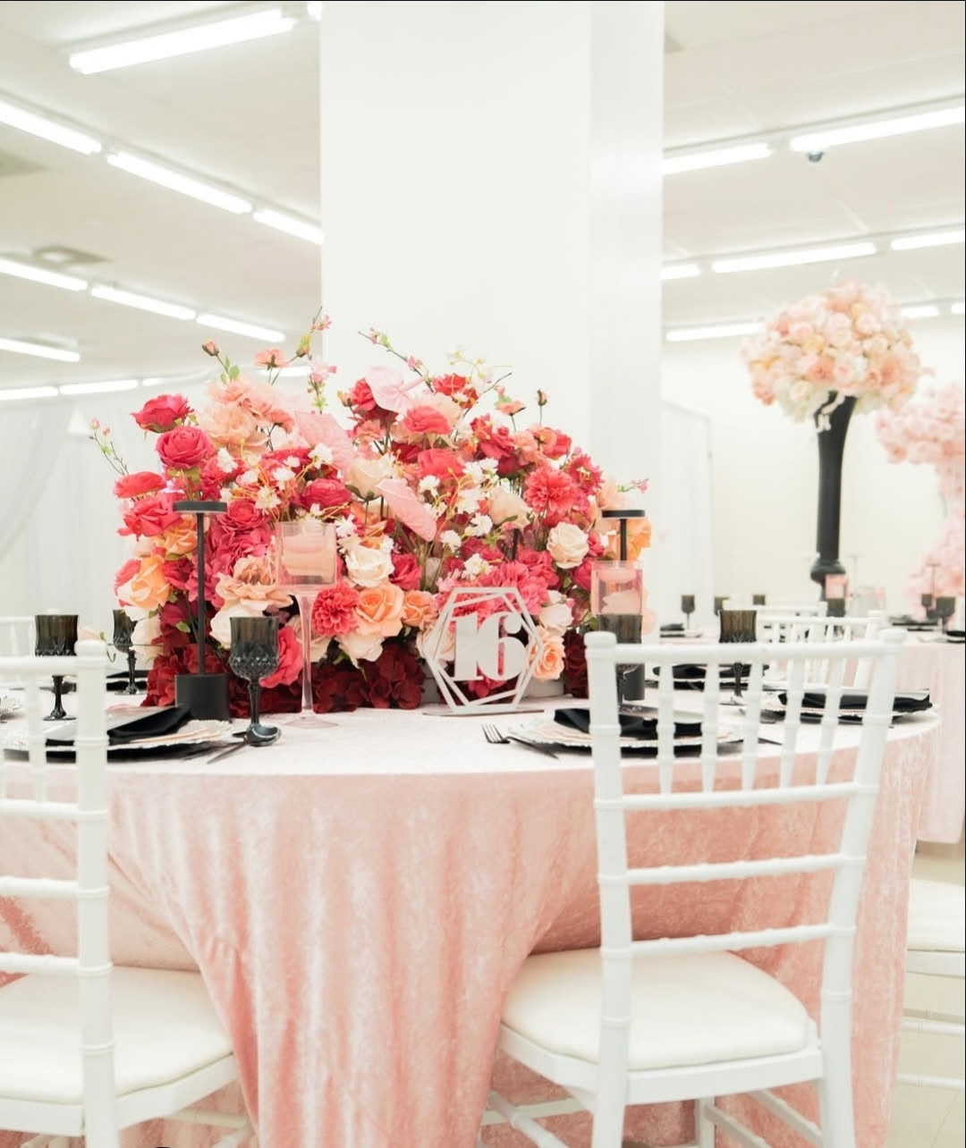 Celebration Hall table decorated with pink linens and floral arrangements